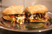 PHILLY CHEESE STEAK ----- rib-eye with sauteed мushrooms, peppers and onion, melted provolone, panini bread
